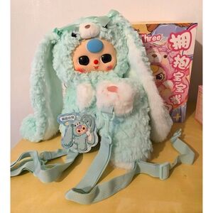 400% Baby Three Hugging Bunny Backpack in a Mint or light green color. 